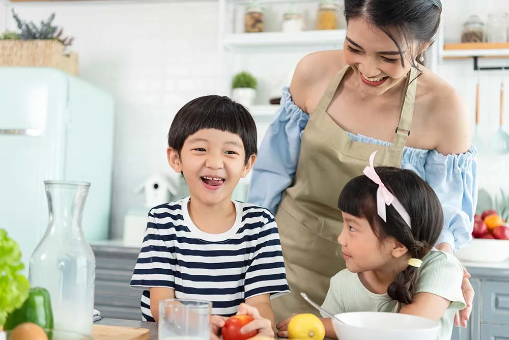 Asian mom in a kitchen with her children